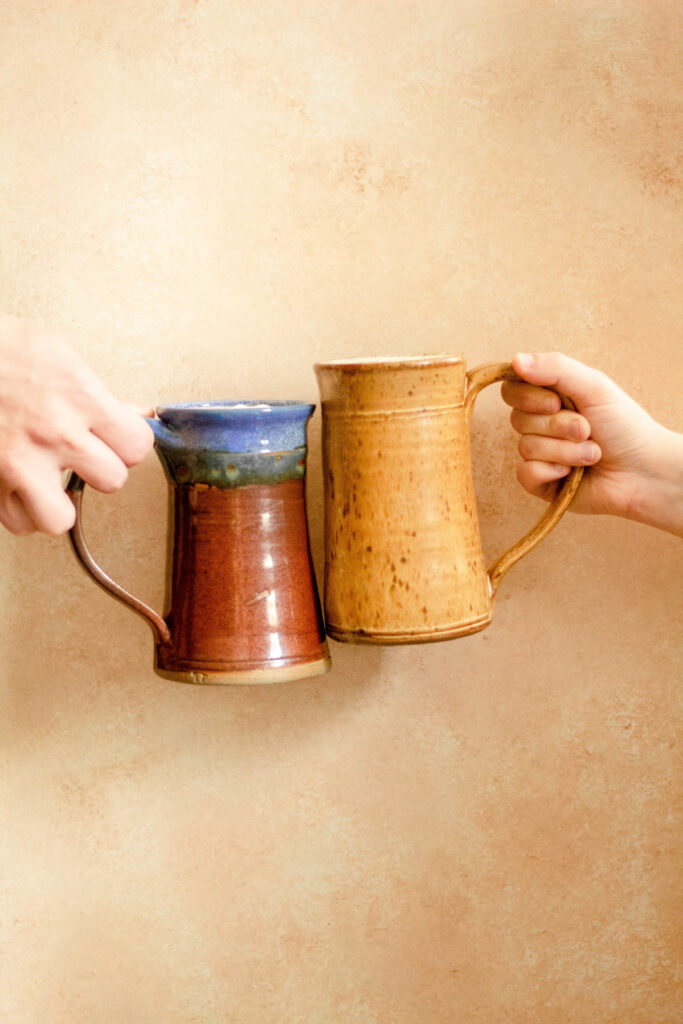 two flagons of harry potter butterbeer cheersing
