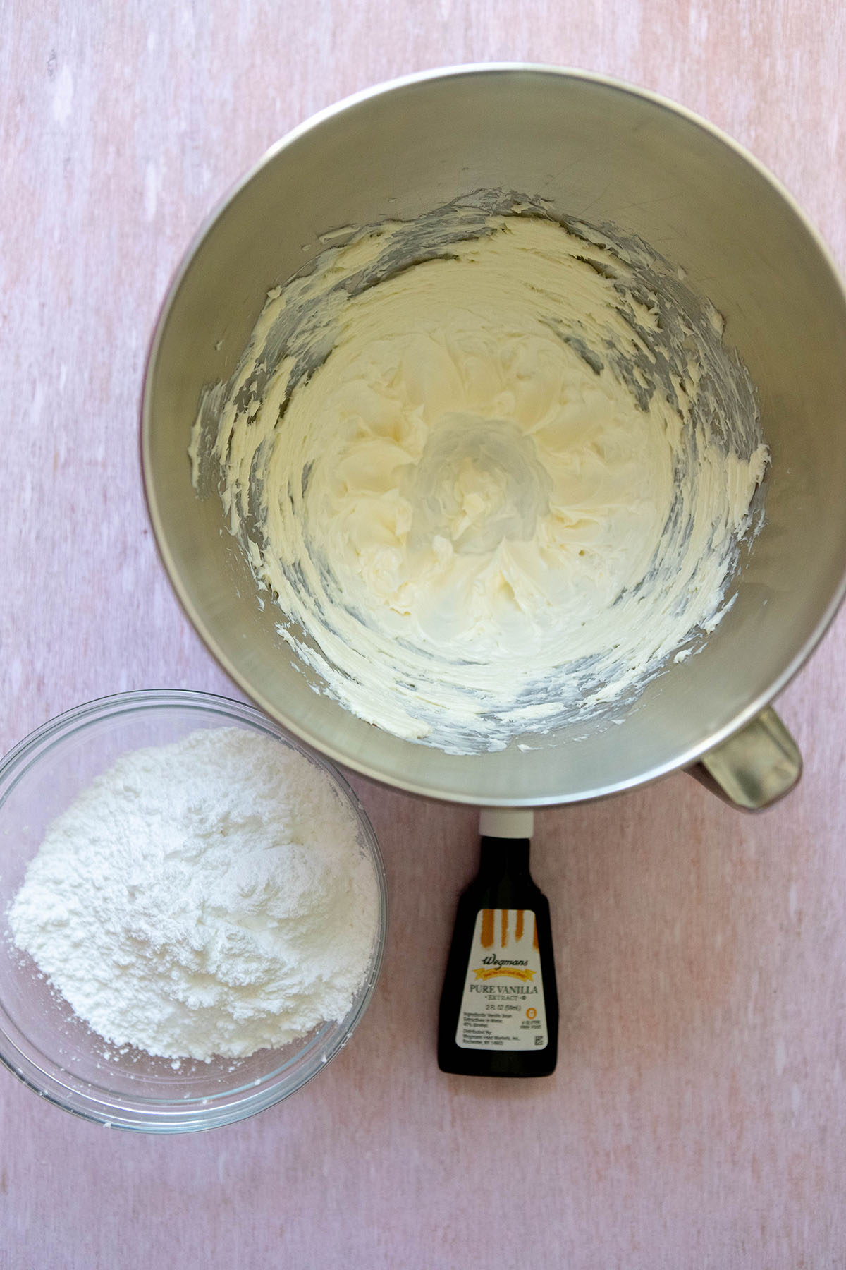 powdered sugar in a bowl next to creamed butter