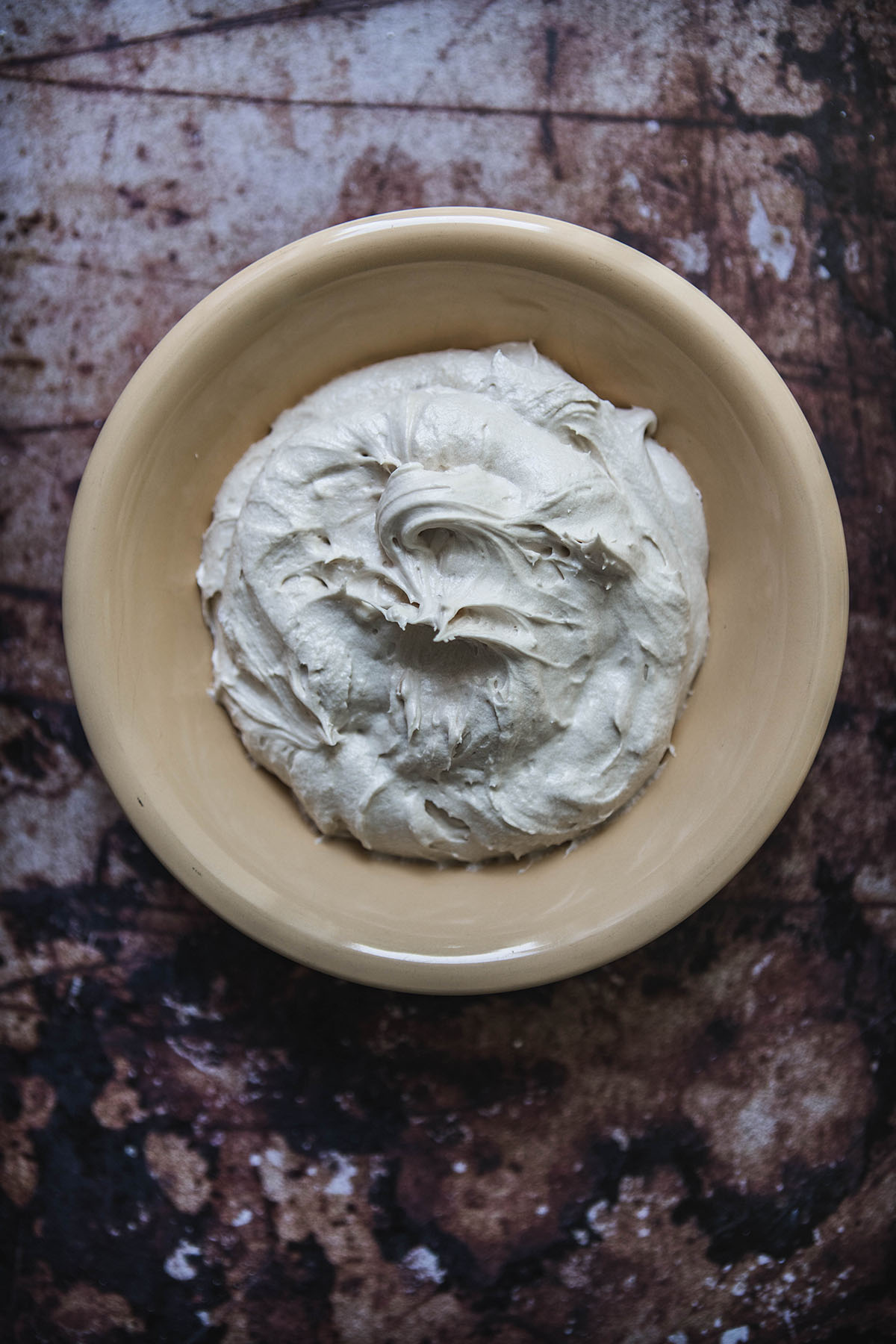 coffee buttercream frosting in a yellow bowl 