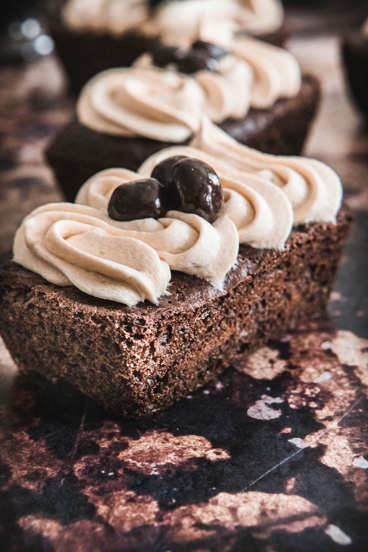 A close-up of creamy coffee buttercream frosting piped on a cake