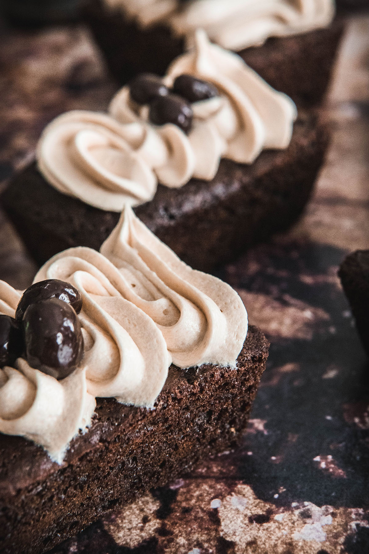 A close-up of creamy coffee buttercream frosting piped on a cake