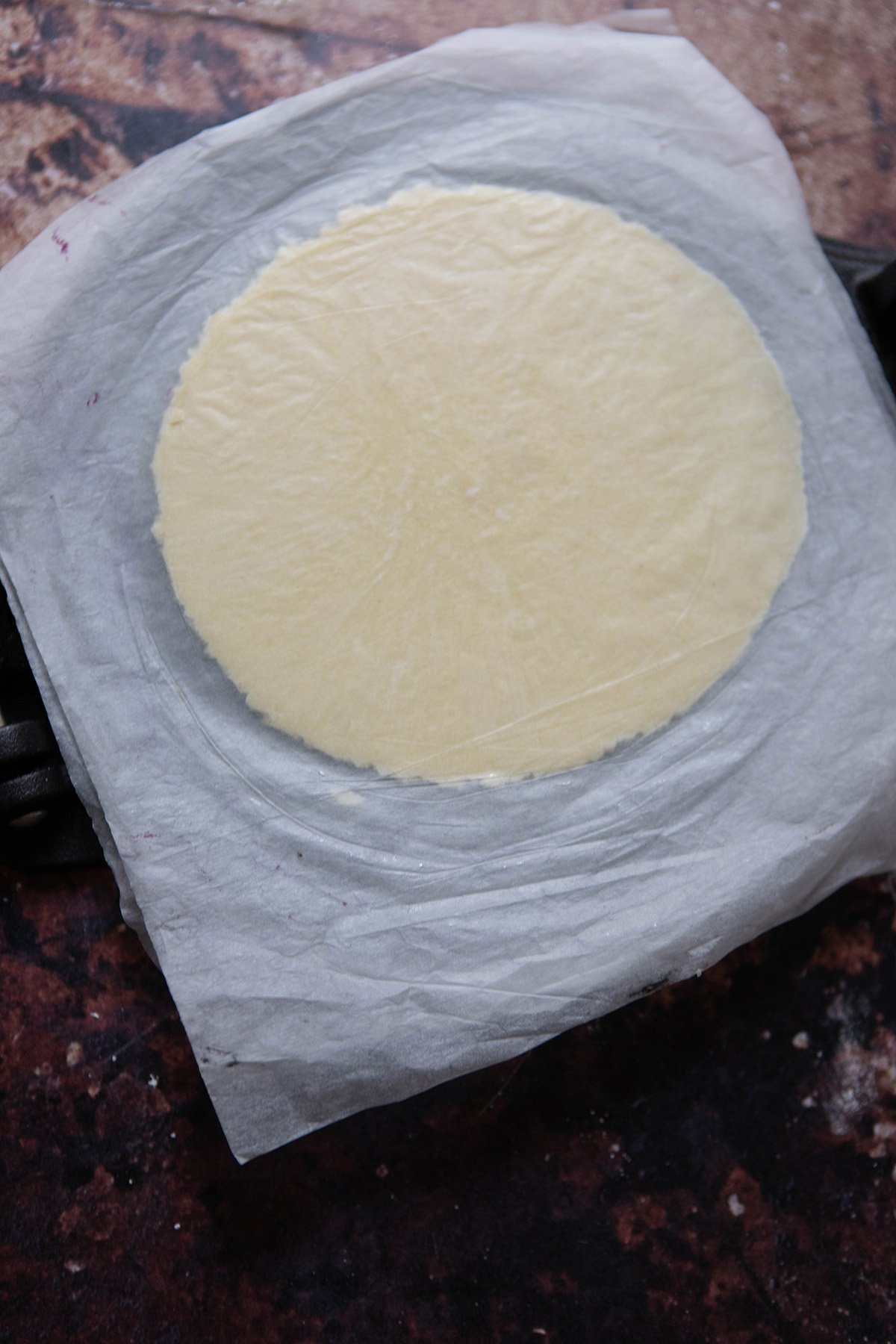 pastry dough between parchment paper