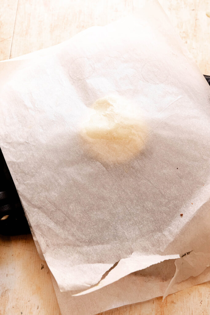 pie dough between parchment paper