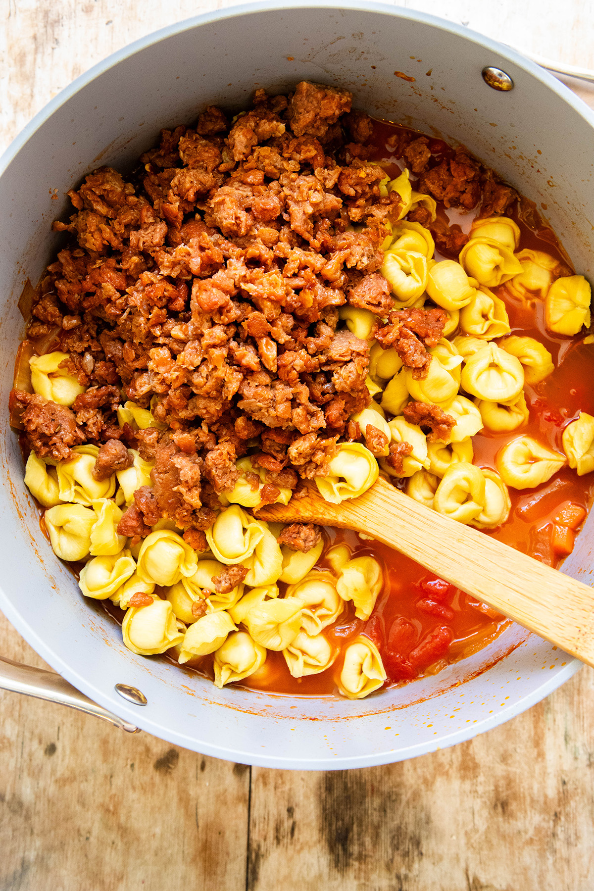 vegetarian sausage on top of tortellini in a soup pot