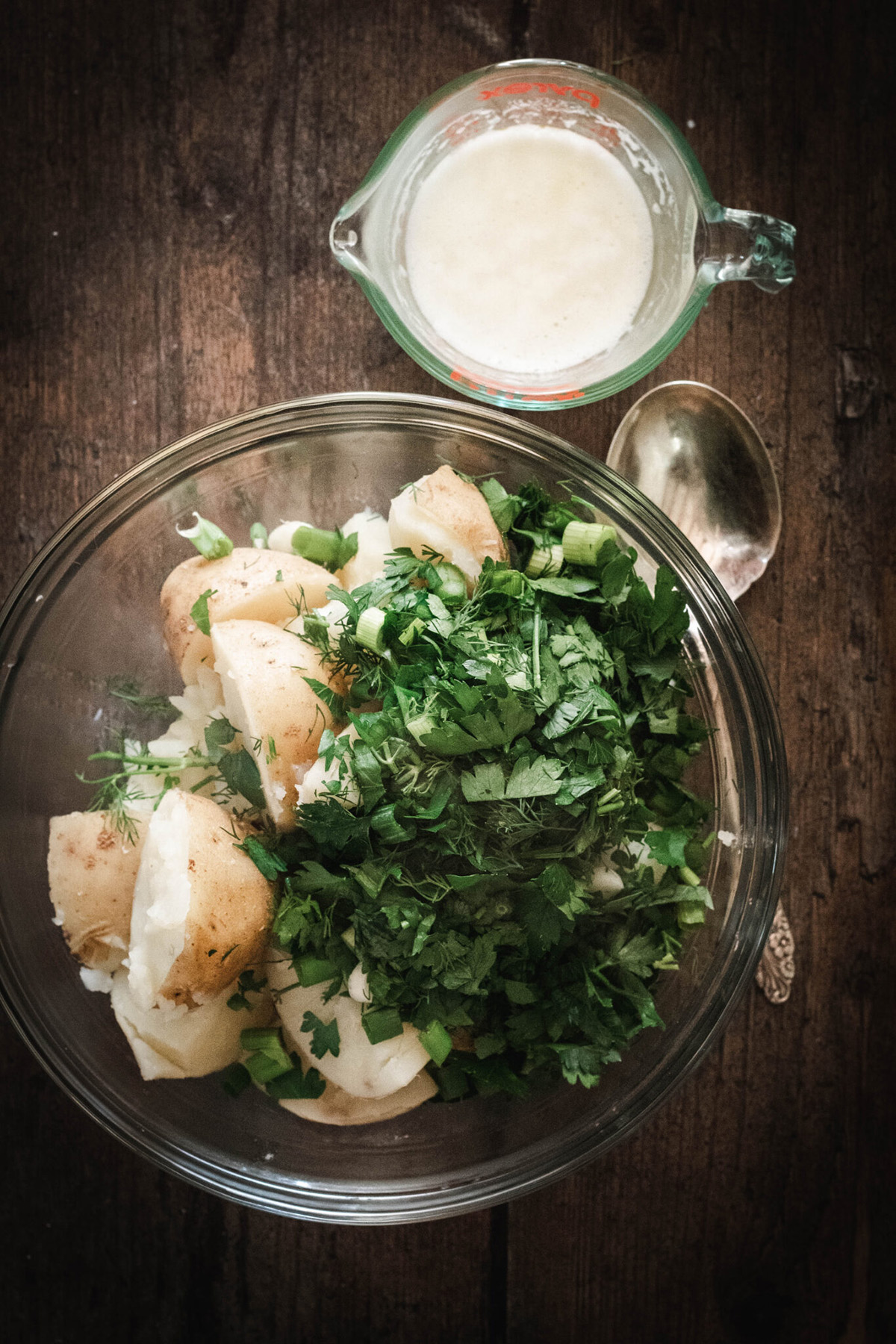 potatoes and herbs in a glass bowl