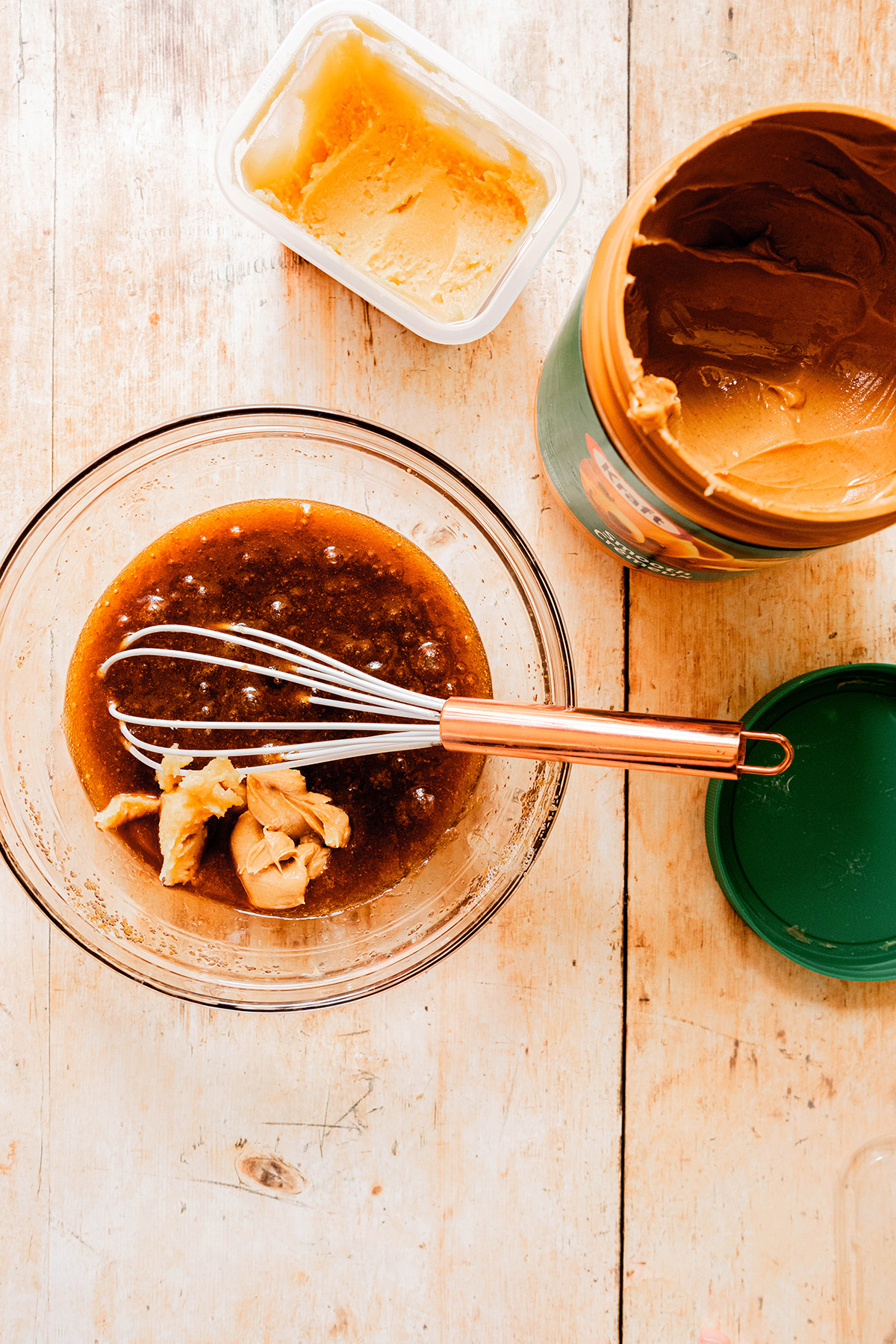 wet ingredients in a glass bowl with peanut butter 