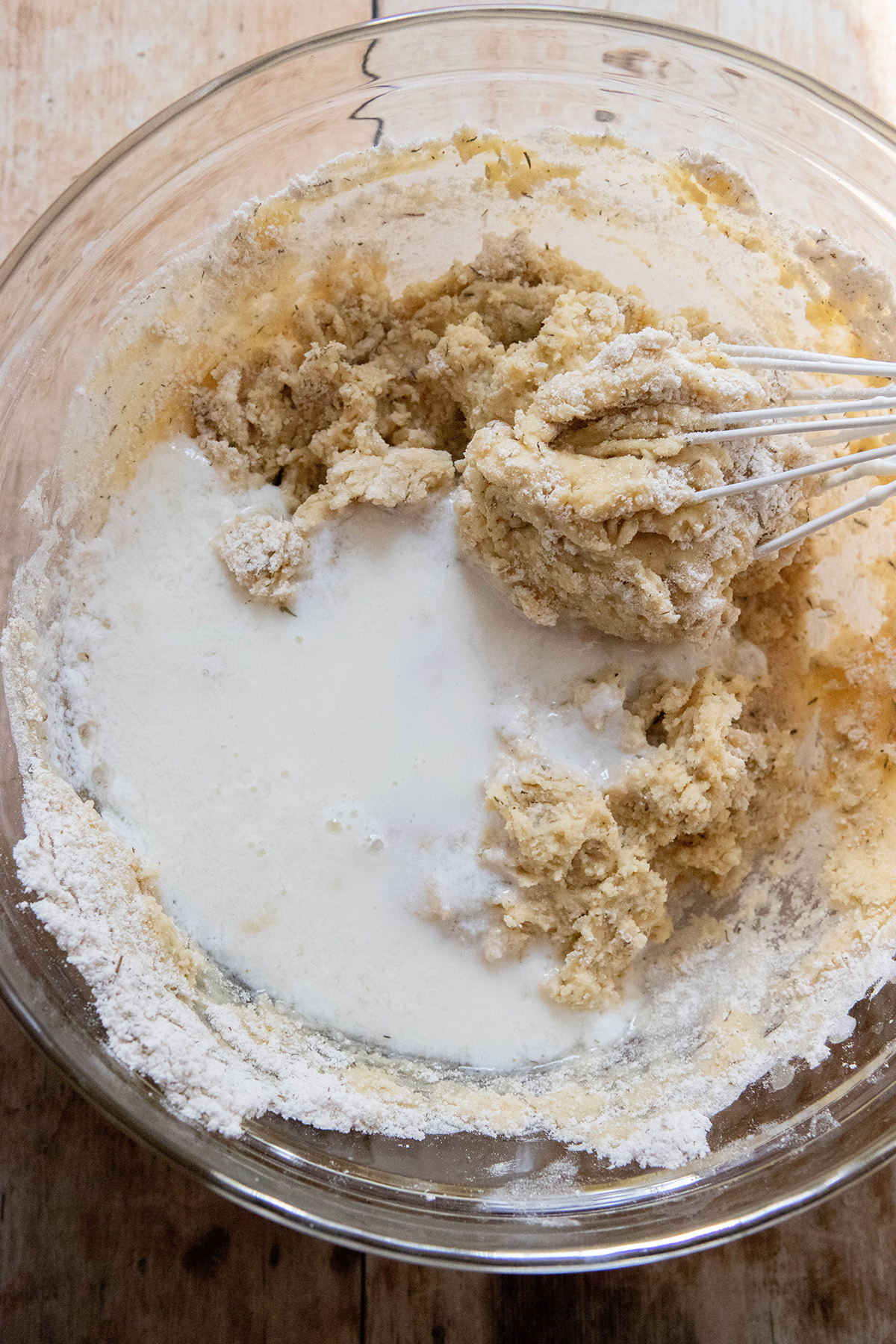 muffin batter in a glass bowl with milk