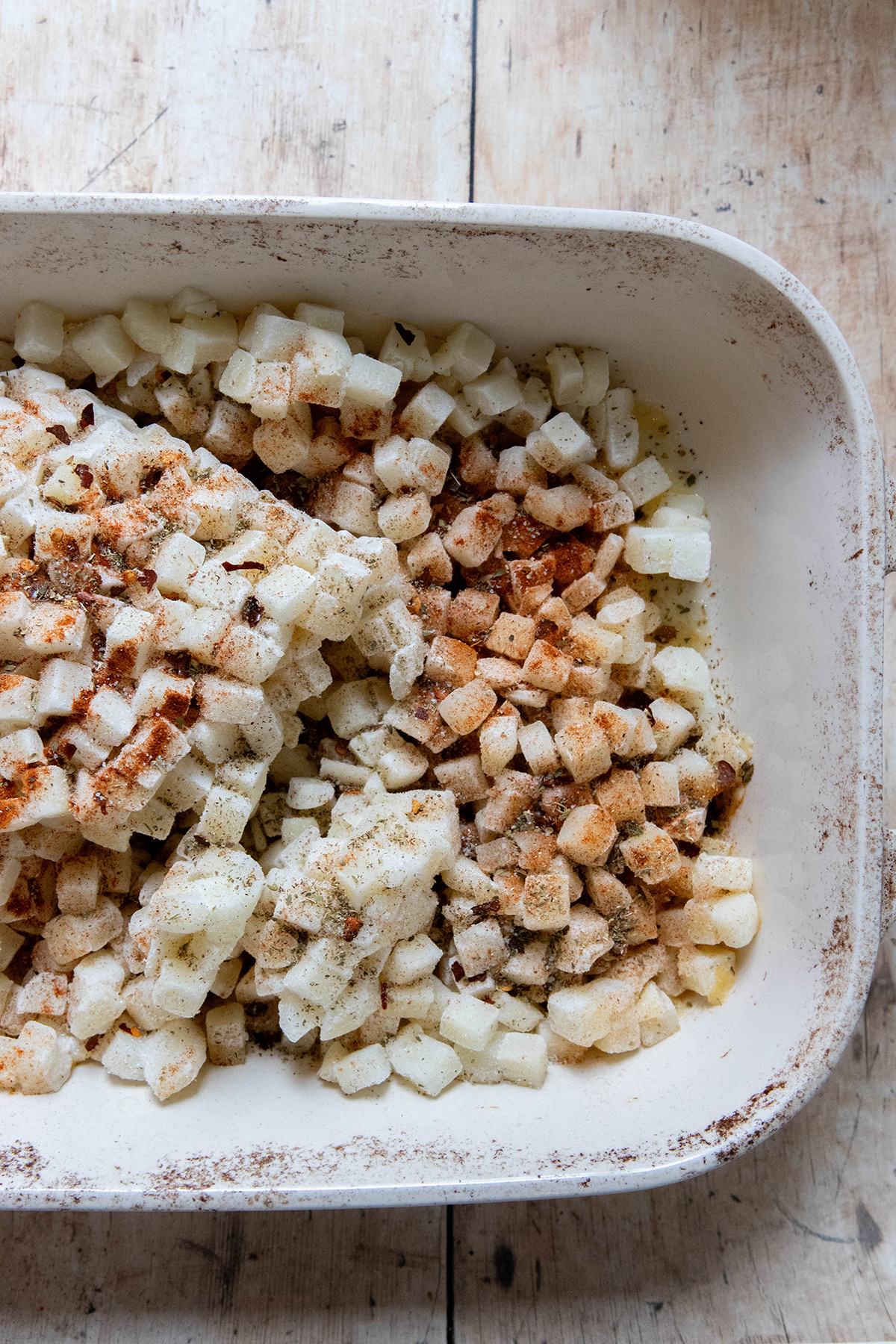 hash browns and spices in a casserole dish