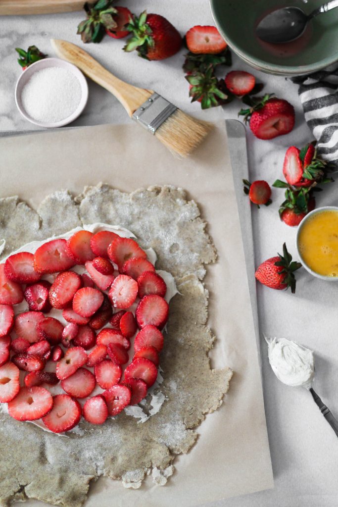Dough rolled out with mascarpone and strawberries