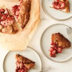 Sliced pieces of galette on three plates and a few on a tray.