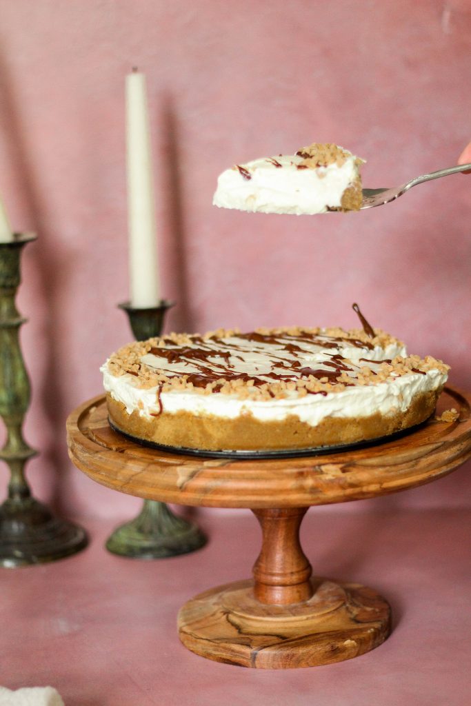 heath bar cheesecake slice being lifted in the air