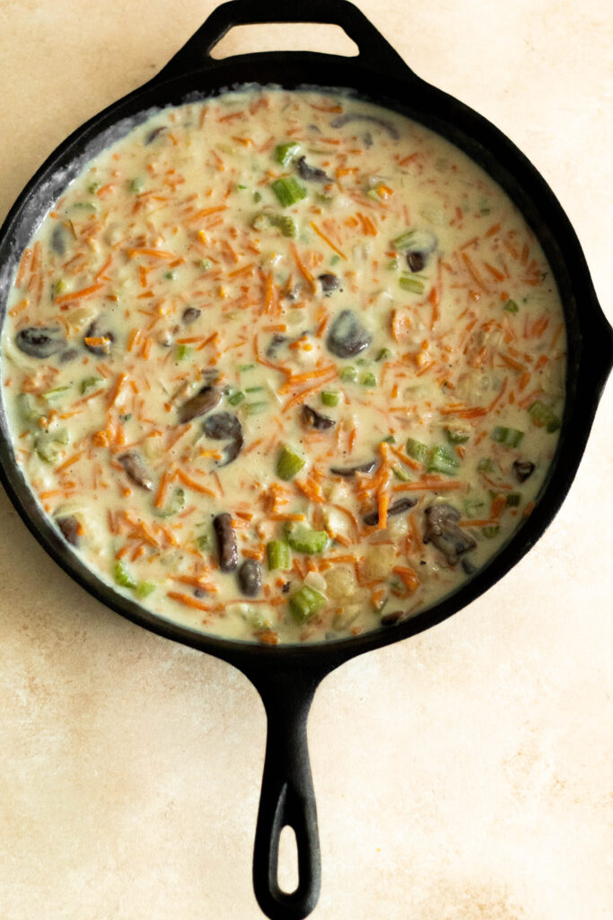 Gluten Free Vegetable Tater Tot Casserole in a cast iron pan.