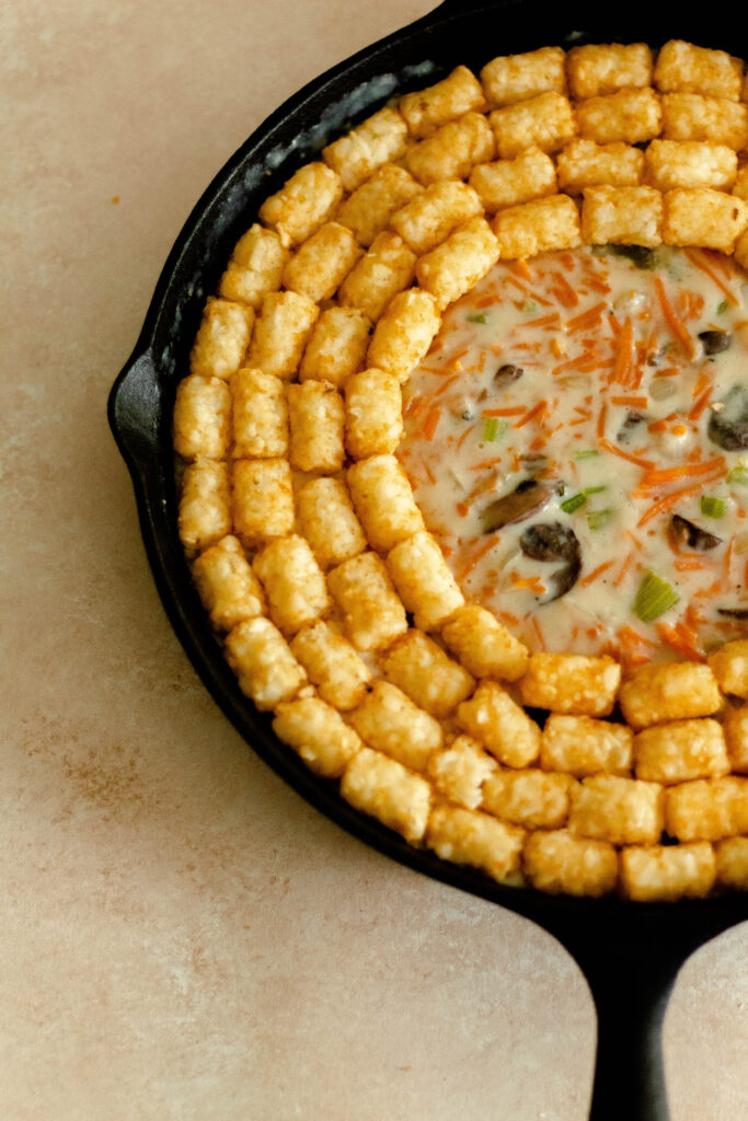 Gluten Free Vegetable Tater Tot Casserole in a cast iron pan.