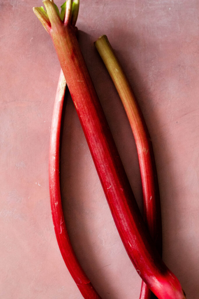 Rhubarb Tart Recipe on a pink background.