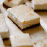 Gluten Free Recipe for Cheesecake Bars on parchment paper