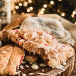 gluten free cranberry orange scones recipe sitting on a board with glaze