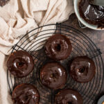 chocolate glazed donuts on a wire rack