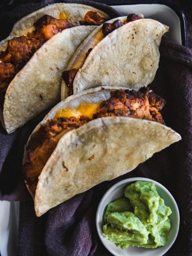 Sweet Potato Black Bean Tacos next to guacamole